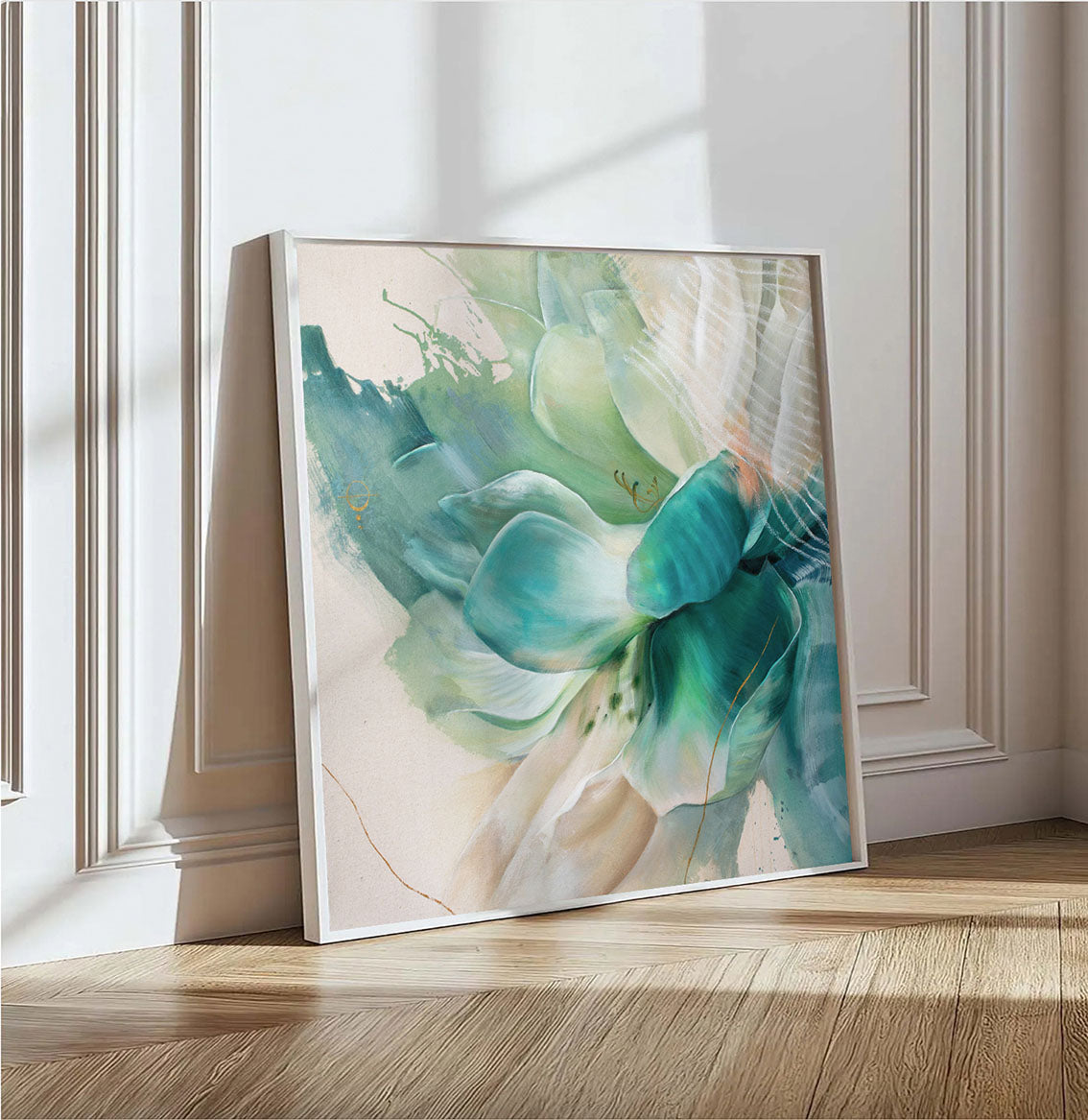 Framed abstract floral fine art print in green and blue colors on a light background, leaning against a wall.